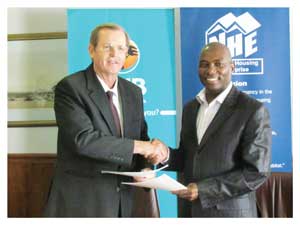 Chief Executive Officer of FNB Namibia, Ian Leyenaar and NHE Chief Executive Officer Vinson Hailulu at the signing ceremony.