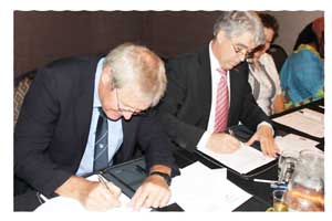 Hans Nolte, vice president and general manager of Namibia Custom Smelters (left), and Dr. Peter Weber, president of the Finnish engineering firm Outotec, at the signing ceremony.