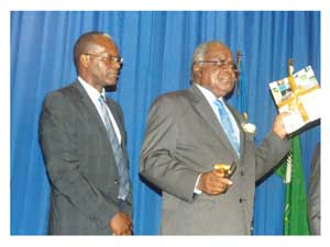 His Excellency President Hifikepunye Pohamba officially launched the Namibia 2011 Population and Housing Census Basic Report while National Planning Commission Director General Tom Alweendo guides the procedures (Photograph by Hilma Hashange)