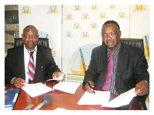 CEO of the Competition Commission, Mihe Gaomab II and Sisheo Simasiku, CEO of the Electricity Control Board, singing a Memorandum of Agreement to establish a framework for both institutions to avoid duplication of mandates and actions where similarities exist in the legislation controlling the two statutory bodies. (Photograph by Lorato Khobetsi)