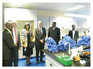 From left to right Dean of the School of Medicine, Prof. Peter Nyarango, German Ambassador to Namibia Otto Huckmann, Managing Director of Air Namibia Ms. Theo Namases, The President of the Johannes Gutenberg University, Professor George Kausch, UNAM’s Vice-Chancellor, Professor Lazarus Hangula and Mr Fillemon Wise examine some of the microscopes that were donated to the Medical School. To the far right, a medical student can be seen using one of the microscopes. (Photograph by Daniel Kavishe)