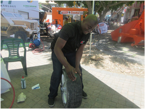 Elkana Jafet, Director of Self Sealing Tyre Technology Namibia demonstrates how Propylene Glycol seals a tyre when it is punctured. (Photograph by Hilmah Hashange).