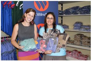 Pictured at the handover are f.l.t.r., Jennieke Bolier, Project Manager of Anusa and Roelien Zwart, Communication Practitioner at Bank Windhoek holding some of the school uniforms produced by Anusa.