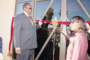 Minister of Finance Saara Kuugongelwa-Amadhila cuts the ribbon of the new DBN office as the Governor of the Erongo Region Cleophas Mutavikua (left) looks on.