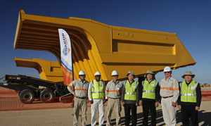 And you thought your bakkie was big: Officials from Swakop Uranium stand in front of the huge the dump bodies which are to be linked to the trucks which are to work on the Husab Mine