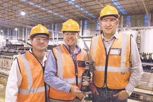Celebrating the new SABMiller bottling run are from the left, Bogart Butler, Technical Manager, Cobus Bruwer, Managing Director SABMiller Namibia, and Wally Tollemache, the construction Project Manager. The elated trio hold the very first batch of Carling Black Label produced in Namibia.